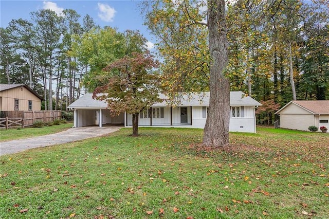 view of front of house with a front yard and a carport