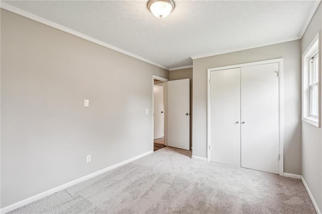 unfurnished bedroom featuring light carpet, a closet, and ornamental molding