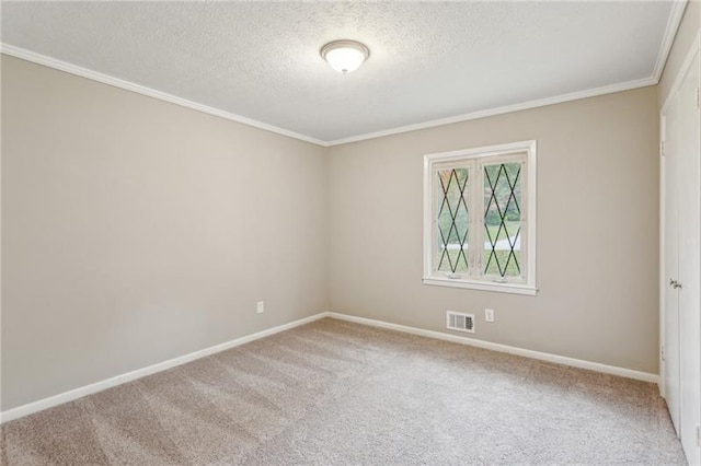 carpeted spare room with a textured ceiling and crown molding