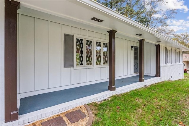 view of property exterior with a porch and a yard