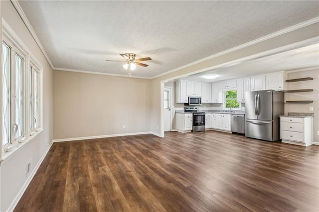 kitchen featuring ceiling fan, stainless steel appliances, dark hardwood / wood-style flooring, white cabinets, and ornamental molding