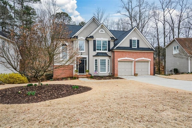 traditional-style home featuring a garage, brick siding, a shingled roof, concrete driveway, and stucco siding