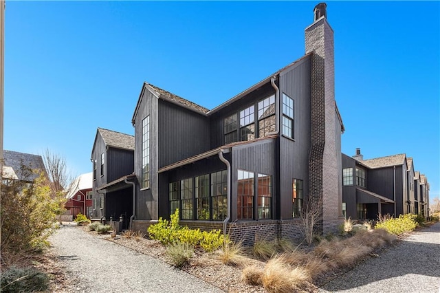 rear view of property with a chimney