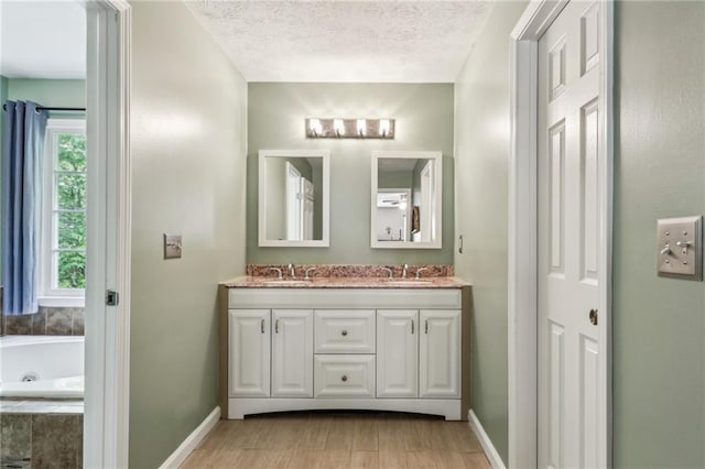 bathroom featuring baseboards, a tub with jets, a healthy amount of sunlight, and wood finished floors