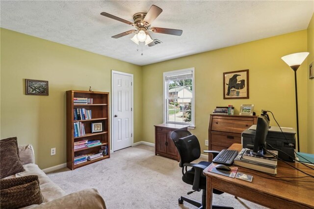office space with carpet floors, a ceiling fan, baseboards, and visible vents