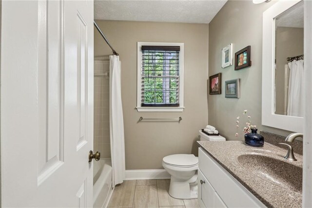 bathroom featuring vanity, baseboards, shower / bath combination with curtain, and toilet