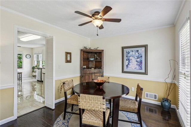 dining space with a ceiling fan, visible vents, dark wood-style floors, and a healthy amount of sunlight