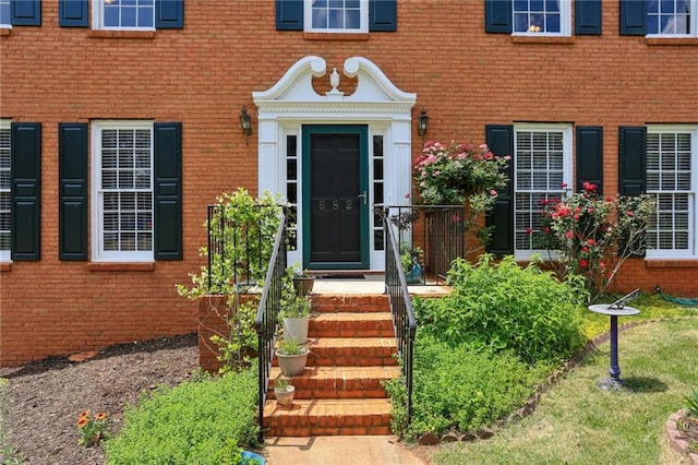 doorway to property with brick siding