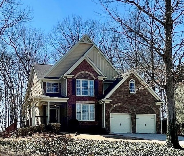 craftsman inspired home featuring a garage, stone siding, board and batten siding, and driveway