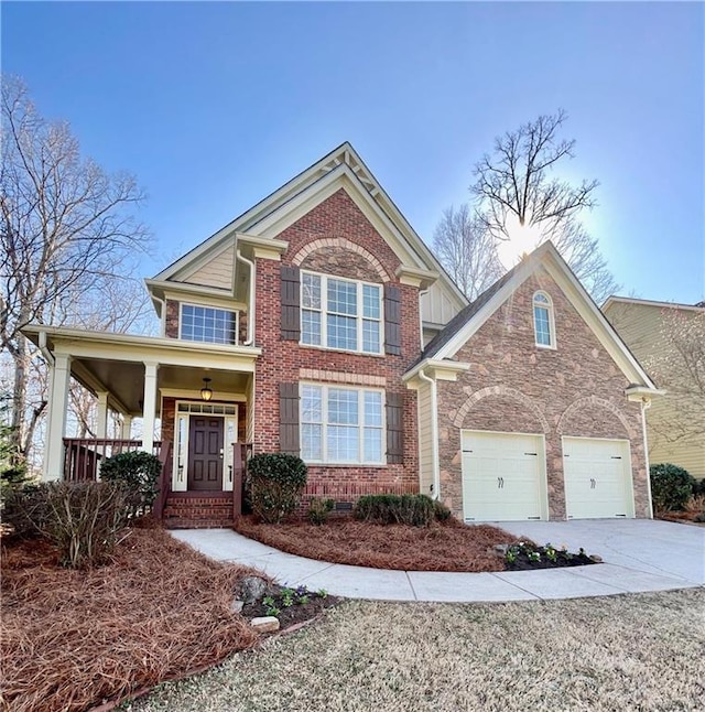 craftsman-style home featuring a garage, driveway, stone siding, board and batten siding, and a front yard