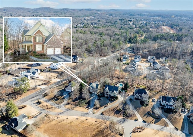 drone / aerial view featuring a wooded view