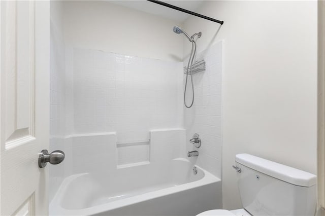 bathroom featuring bathtub / shower combination and toilet