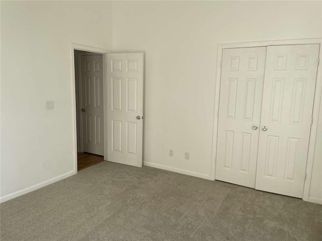 unfurnished bedroom featuring carpet floors and a closet