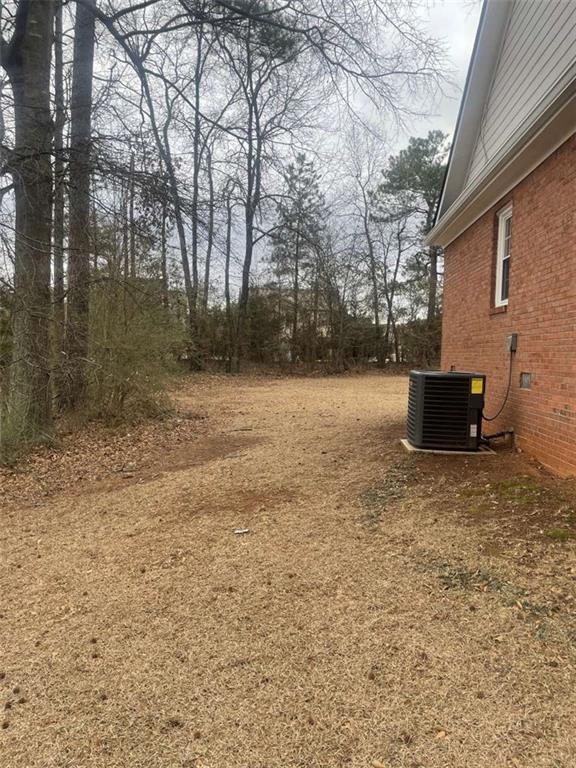 view of yard featuring central AC unit