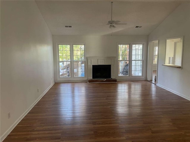 unfurnished living room featuring plenty of natural light, dark hardwood / wood-style floors, lofted ceiling, and ceiling fan