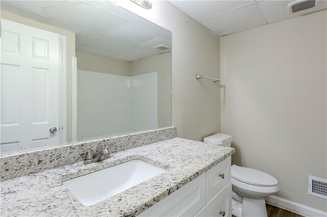 3225 Redona Dr, Atlanta, GA 30349 - bathroom with a shower, toilet, a paneled ceiling, and vanity