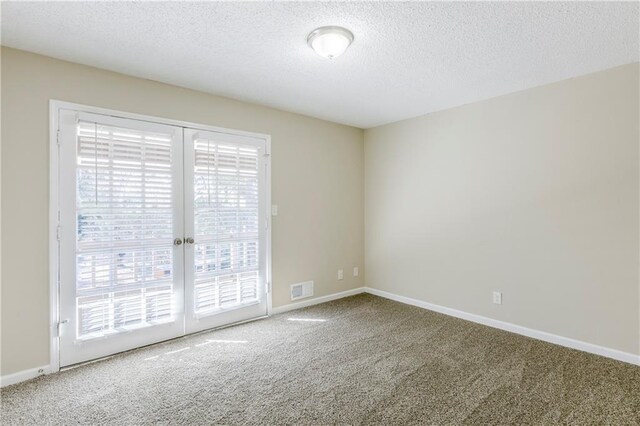 3225 Redona Dr, Atlanta, GA 30349 - carpeted empty room with a textured ceiling and french doors