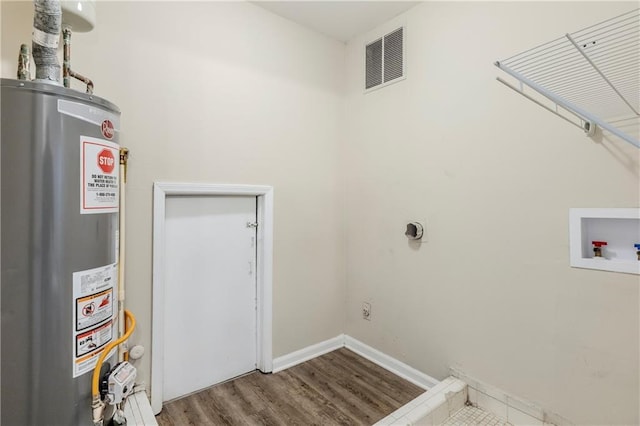 3225 Redona Dr, Atlanta, GA 30349 - clothes washing area featuring hookup for a washing machine, water heater, hookup for an electric dryer, and hardwood / wood-style floors