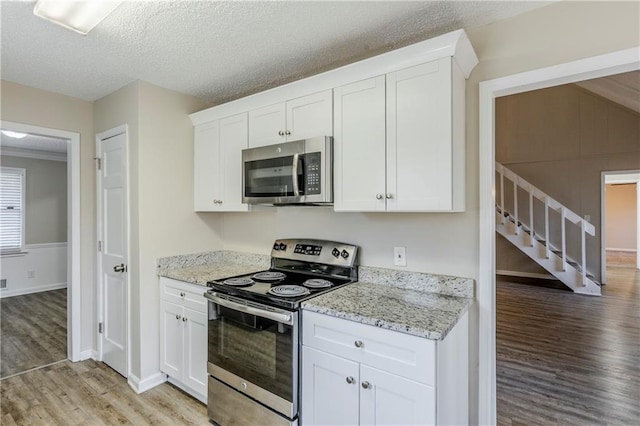 3225 Redona Dr, Atlanta, GA 30349 - kitchen featuring stainless steel appliances, white cabinetry, and light stone counters