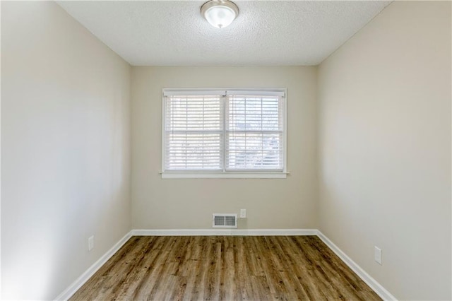 3225 Redona Dr, Atlanta, GA 30349 - spare room featuring a textured ceiling and hardwood / wood-style floors