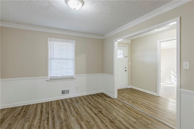 3225 Redona Dr, Atlanta, GA 30349 - spare room with hardwood / wood-style flooring, crown molding, and a textured ceiling