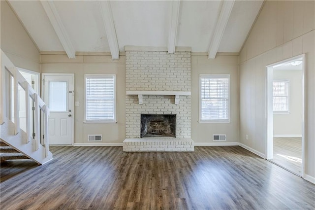 3225 Redona Dr, Atlanta, GA 30349 - unfurnished living room with hardwood / wood-style floors, vaulted ceiling with beams, and a fireplace