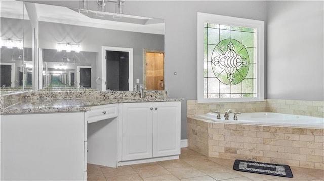 full bath with a healthy amount of sunlight, tile patterned floors, vanity, and a garden tub