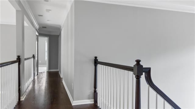 hall with crown molding, baseboards, an upstairs landing, and dark wood-style floors