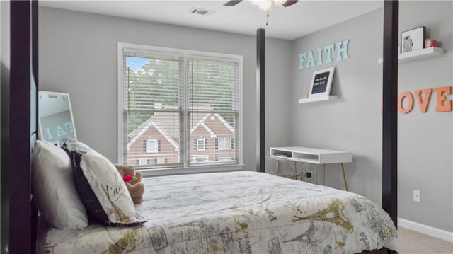 carpeted bedroom with baseboards, ceiling fan, and visible vents