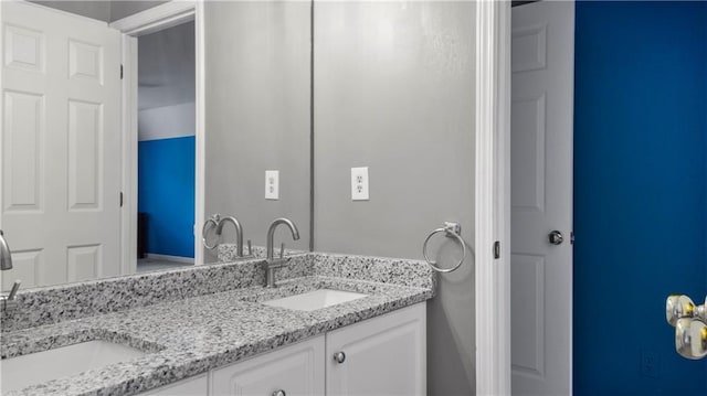 full bathroom featuring double vanity and a sink