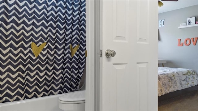 bathroom with shower / bathtub combination with curtain and toilet
