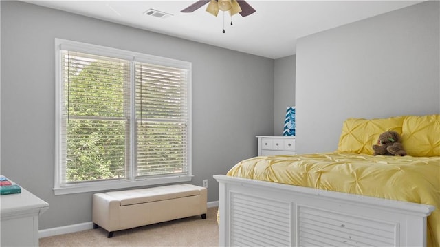 bedroom with baseboards, visible vents, multiple windows, and light carpet