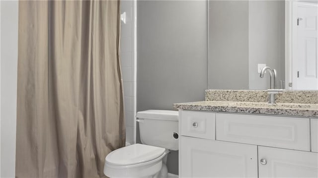bathroom with vanity, a shower with curtain, and toilet