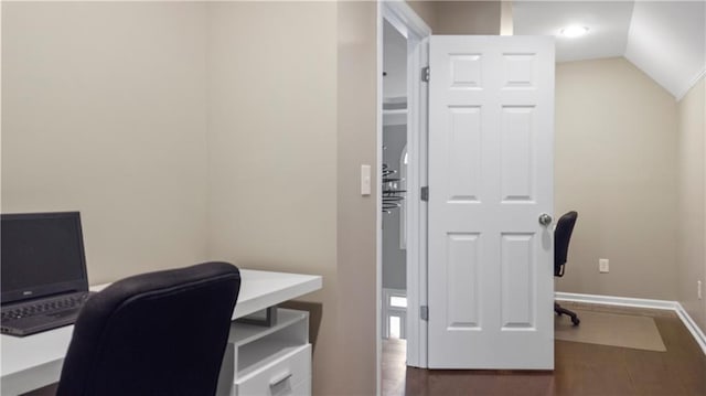 office area featuring baseboards, lofted ceiling, and wood finished floors