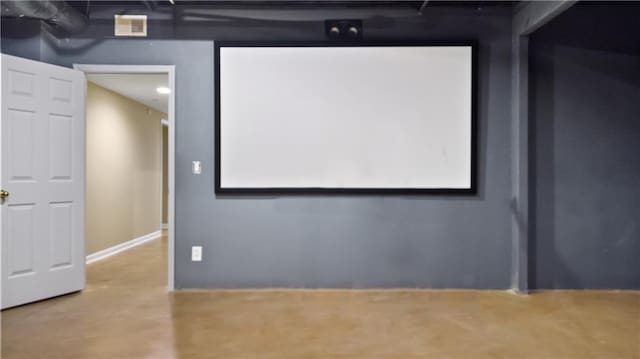 home theater room with concrete floors and visible vents