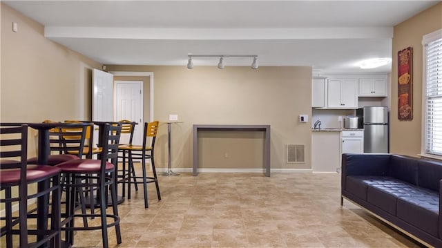 dining area featuring visible vents, baseboards, and track lighting