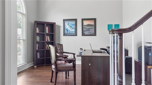 office area featuring baseboards, visible vents, wood finished floors, and a wealth of natural light