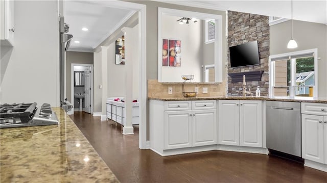kitchen featuring crown molding, appliances with stainless steel finishes, plenty of natural light, and tasteful backsplash