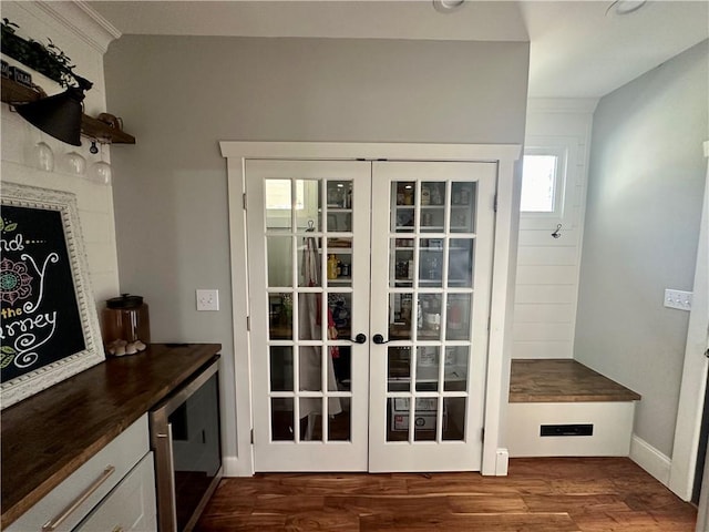 doorway to outside featuring dark hardwood / wood-style flooring and beverage cooler