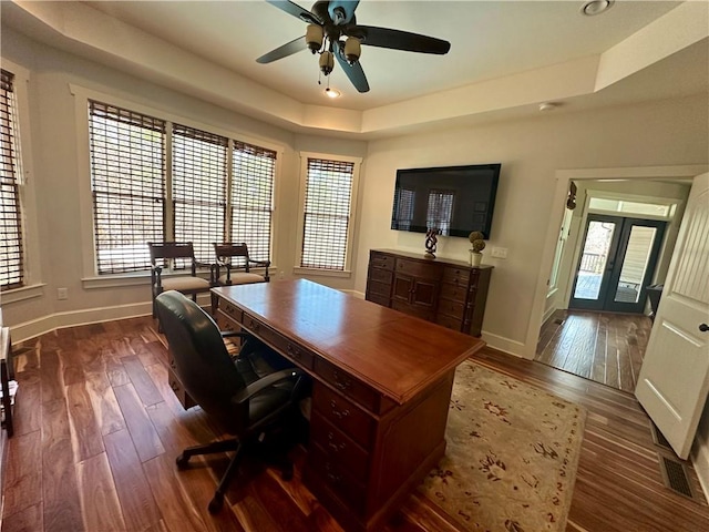 office area featuring a wealth of natural light, french doors, ceiling fan, and dark hardwood / wood-style flooring