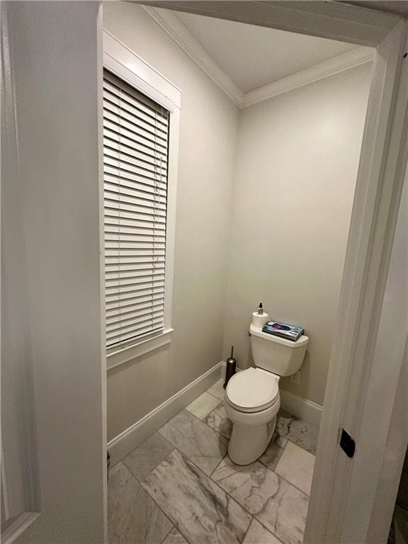 bathroom with toilet and crown molding