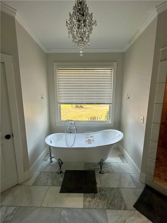 bathroom with ornamental molding, an inviting chandelier, and a washtub