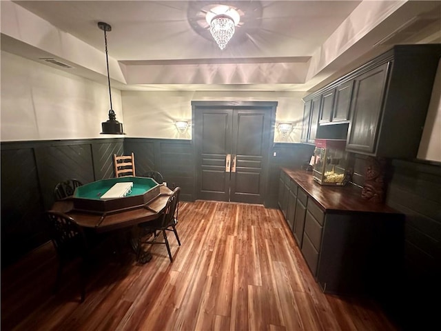 interior space with wood counters, hanging light fixtures, and hardwood / wood-style floors