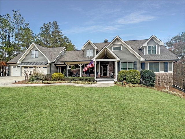 craftsman house with covered porch, a front yard, and a garage