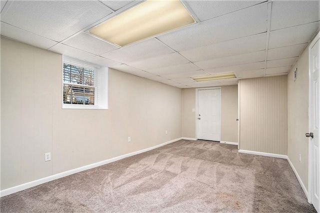 basement featuring carpet flooring and a drop ceiling