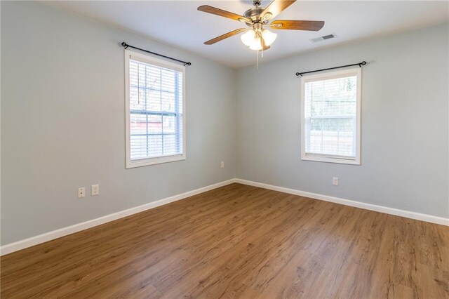 unfurnished room with ceiling fan and wood-type flooring