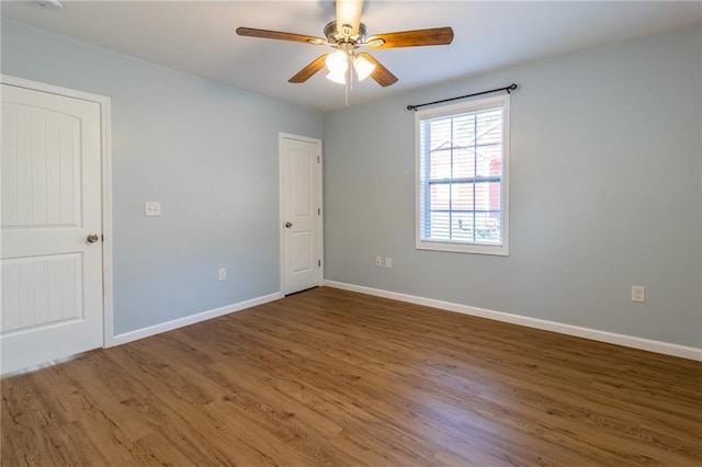 empty room featuring ceiling fan and hardwood / wood-style flooring