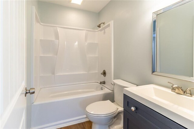 full bathroom featuring vanity, toilet, wood-type flooring, and shower / tub combination