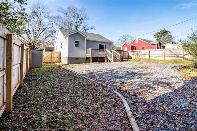 rear view of property featuring a wooden deck