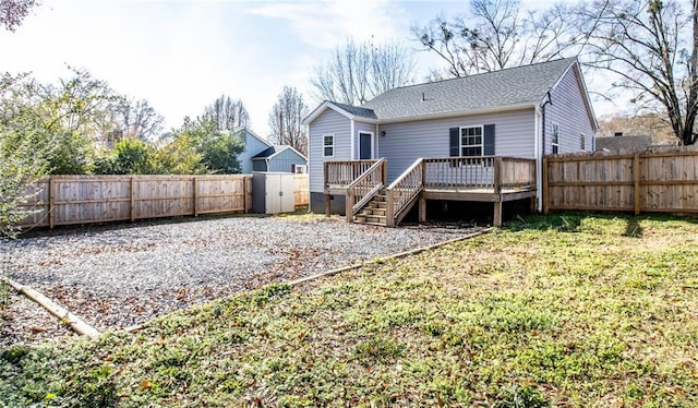 back of house with a lawn and a wooden deck